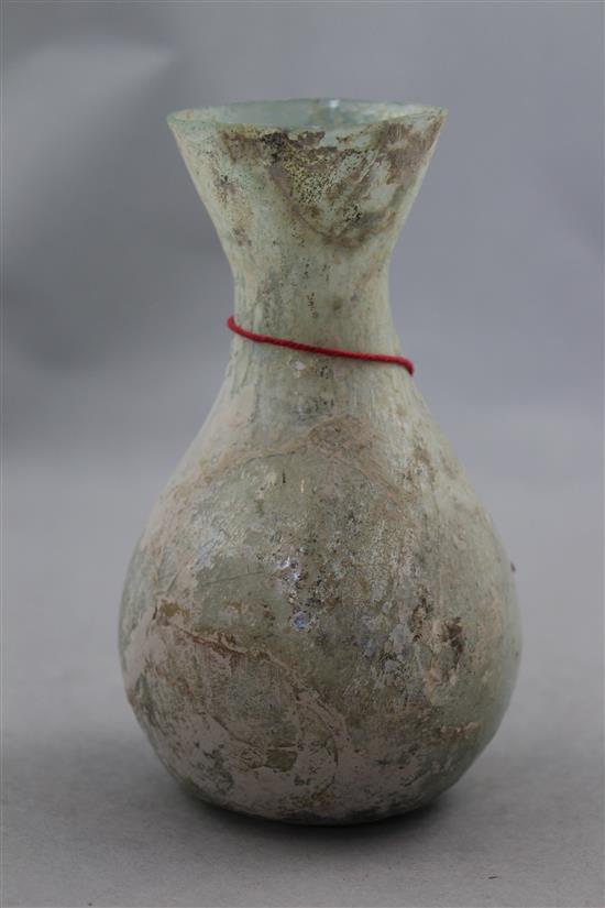 An Islamic glass bottle shaped vessel, c.400 AD, 15cm, cracks